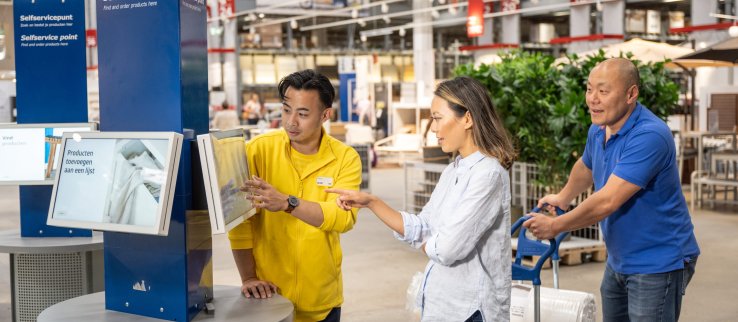 Customers receiving help from an IKEA staff member