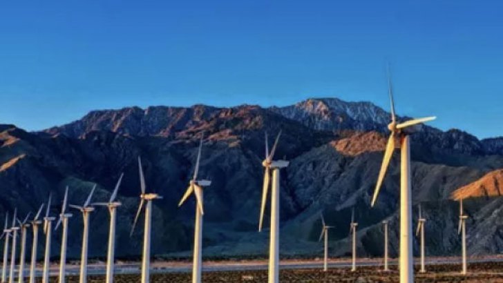 Wind turbines in front of a mountain